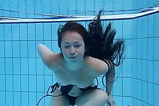 Cute Umora is swimming nude in the pool